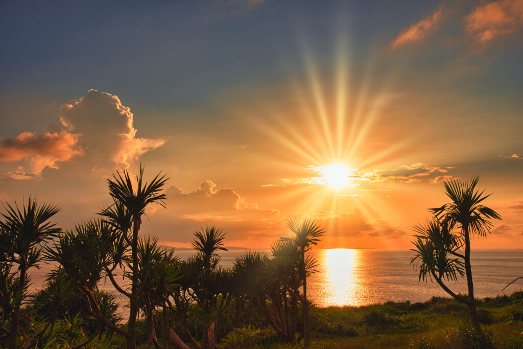 沖縄の海に沈む美しい夕日、久米島オーシャンジェットで楽しむ離島旅のワンシーン